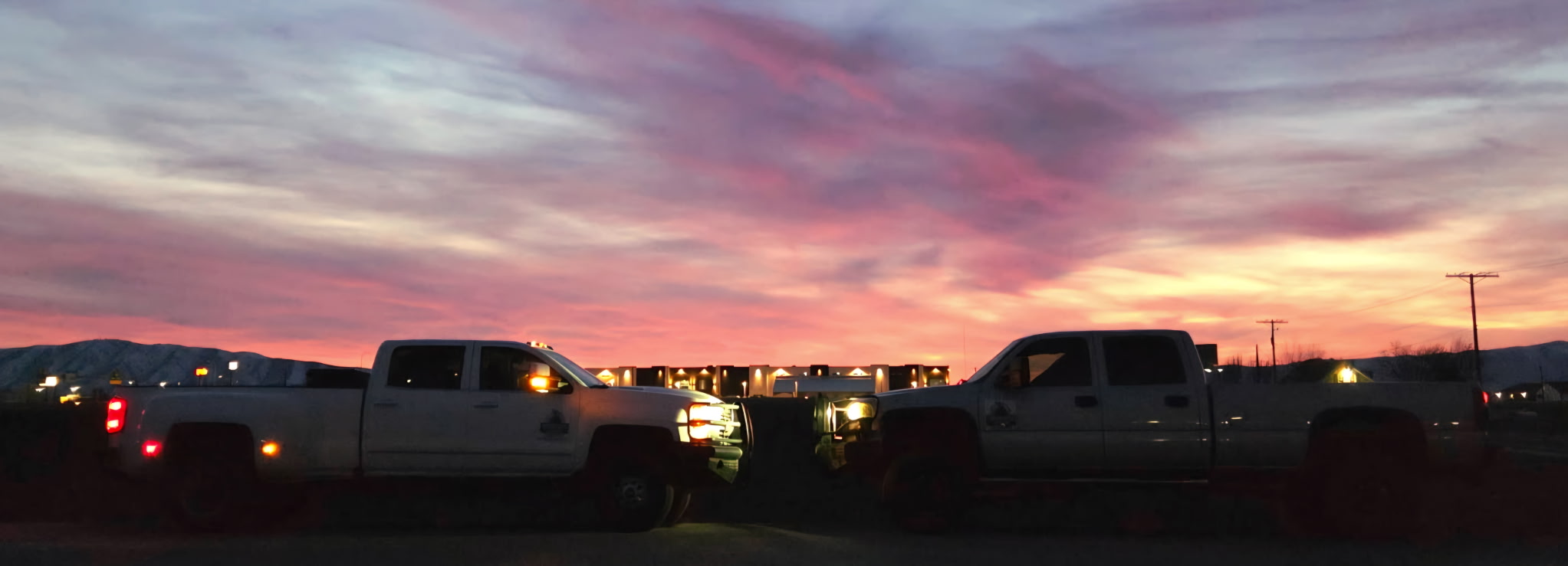 Tipping Rock trucks side by side at sunset